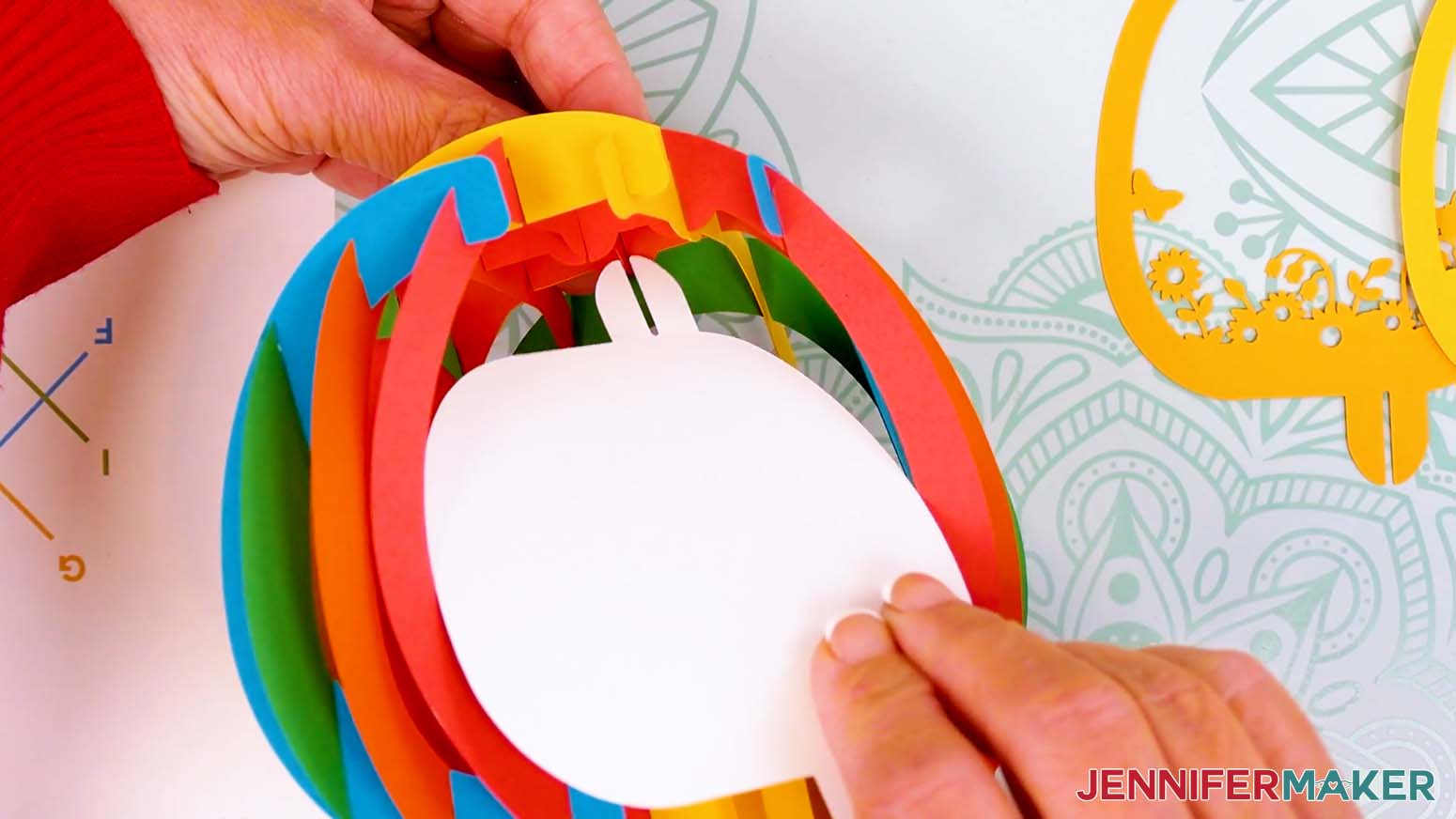 Pinch the back bump from the top outside of the paper pop up Easter egg's shell to insert the back scene layer's tab.
