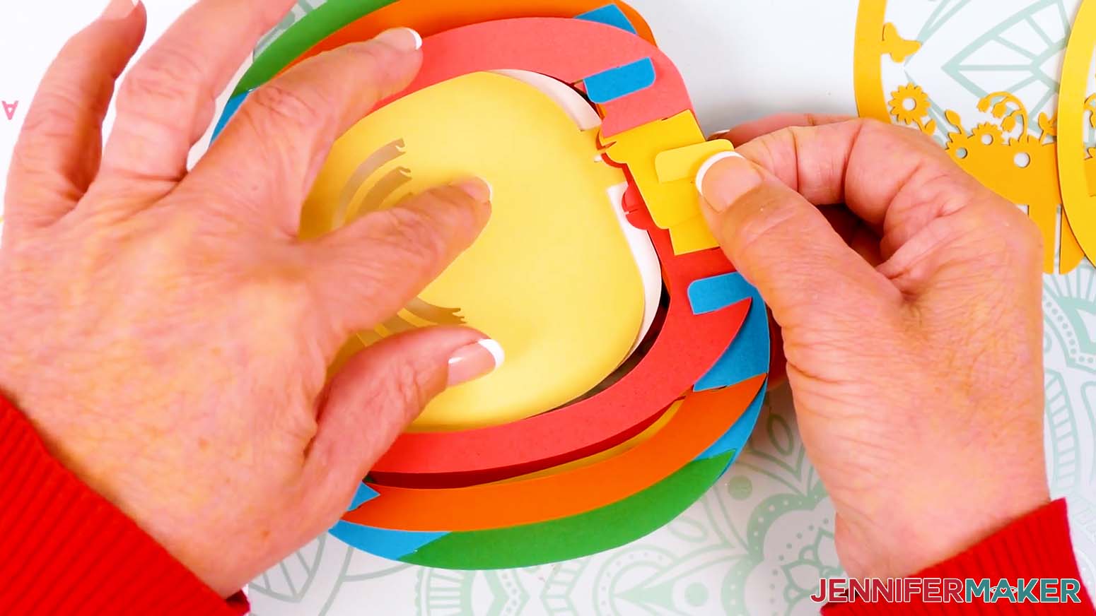 Insert the second scene layer's tab into the bottom bump of the pop up easter egg's shell.