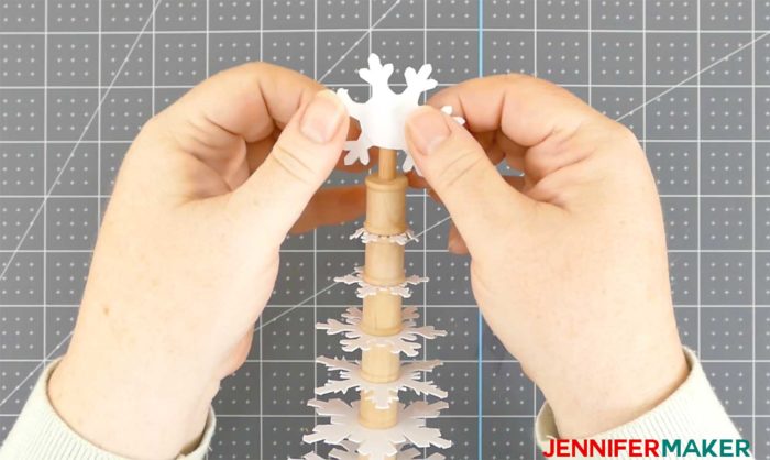 Slide the paper snowflake topper onto the paper snowflake Christmas tree