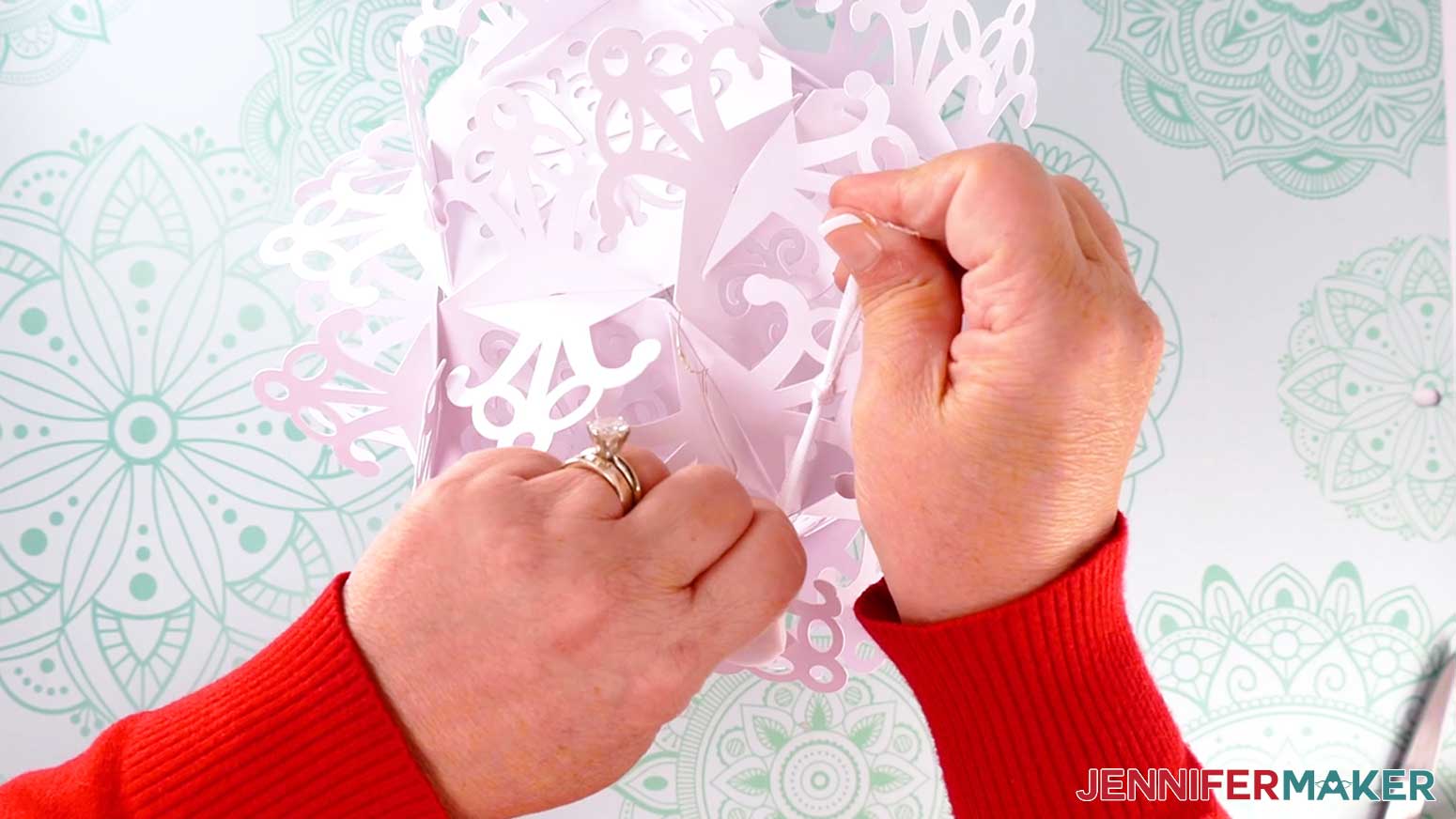 a ribbon is fed through two holes.