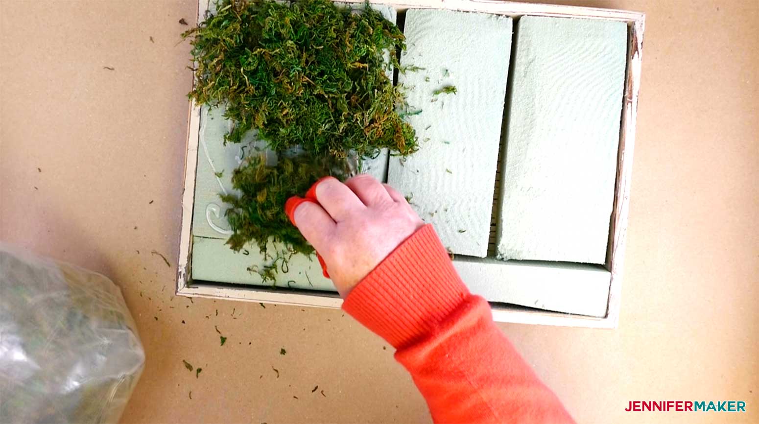 Push moss into the hot glue on the floral foam for my paper succulents project