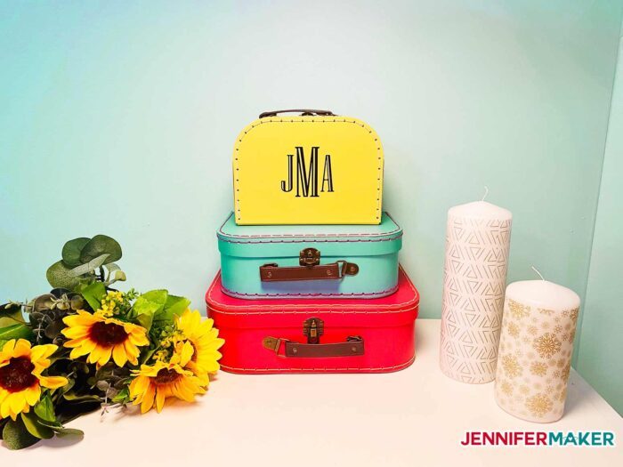 Yellow, blue, and red paperboard suitcases with removable vinyl are an easy home decor idea