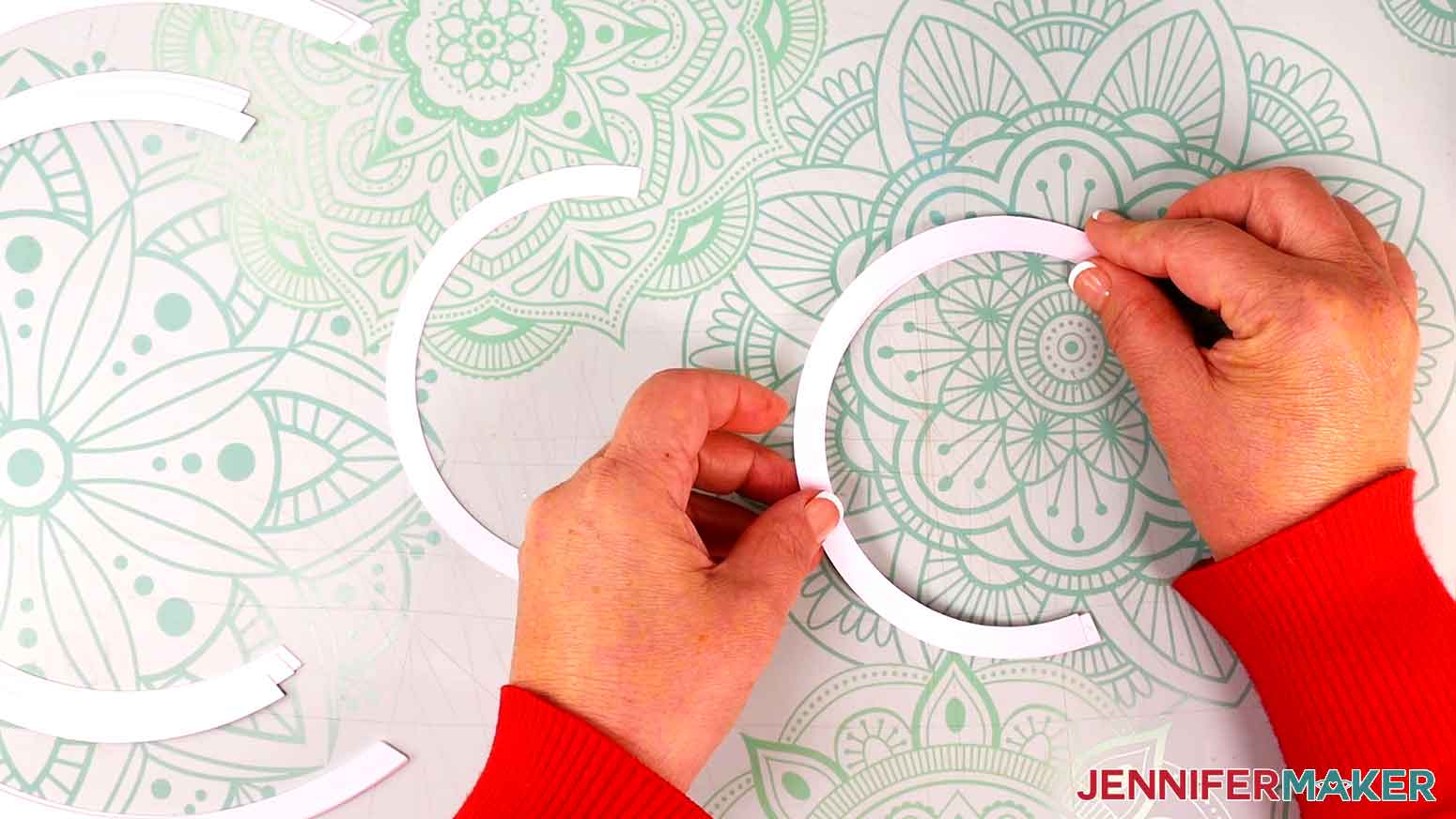 Align the first two smallest track pieces for the perpetual calendar before pressing down to adhere the glue