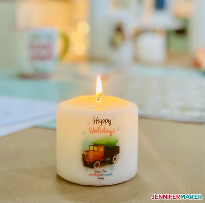 White pillar candle with printed image transferred onto it for the holidays