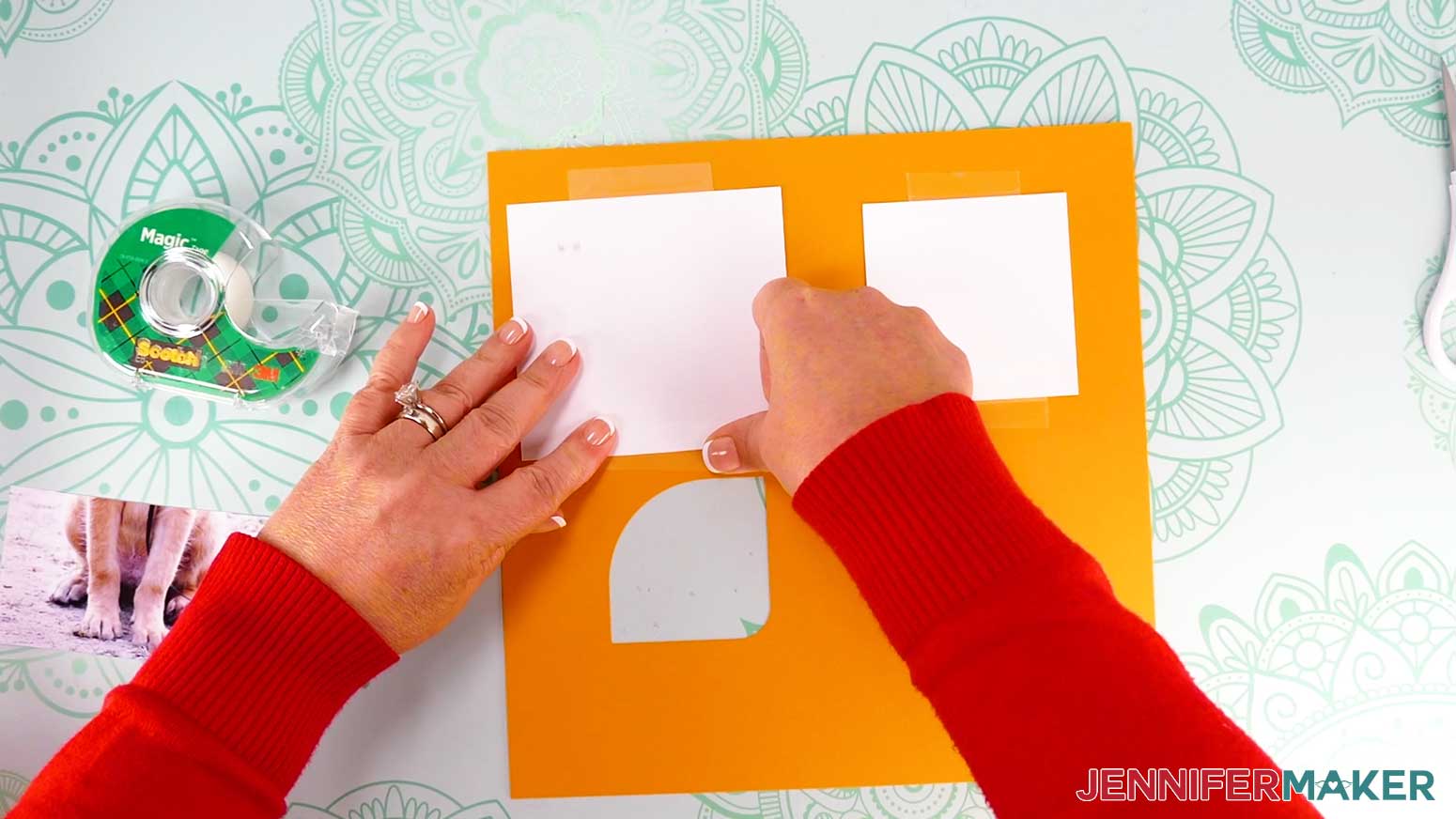 Press the paper frame onto the clear tape, then flip the frame and attached photo over and press the tape from the other side to make sure it adheres well.