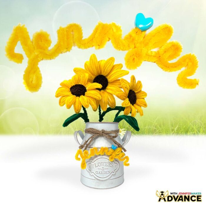 Easy Pipe Cleaner Flowers in a white vase, tied with twine, crafted with yellow pipe cleaners to look like realistic sunflowers. A yellow pipe cleaner name "Jennifer" decorates the vase