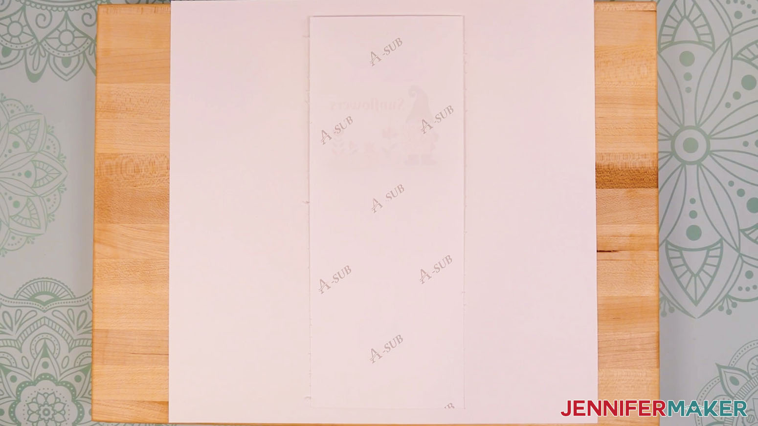 Place the taped design and garden marker blank on the cardstock with the design face down.