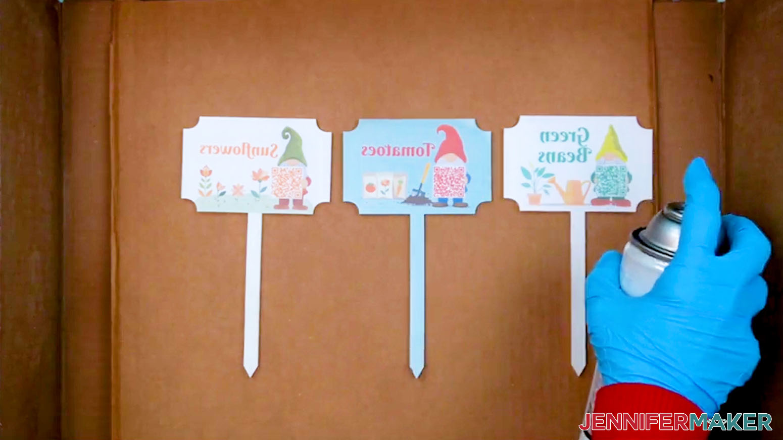 Spray a protective coating on the pressed plant care markers.