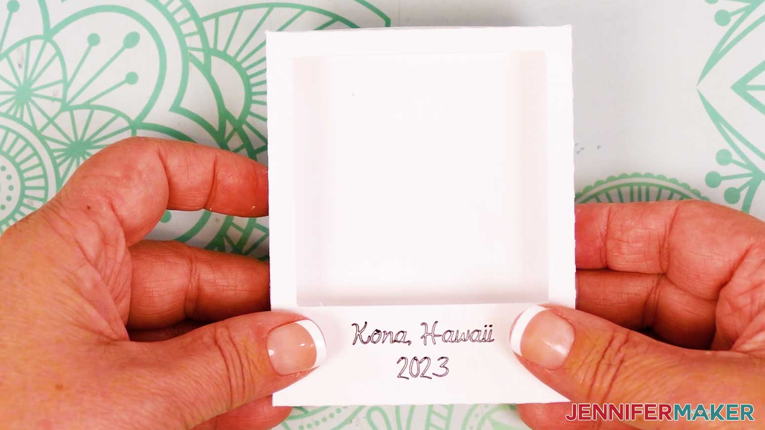 The assembled cardstock frame for the Polaroid Shadow Box, with "Kona, Hawaii 2023" written on the front.