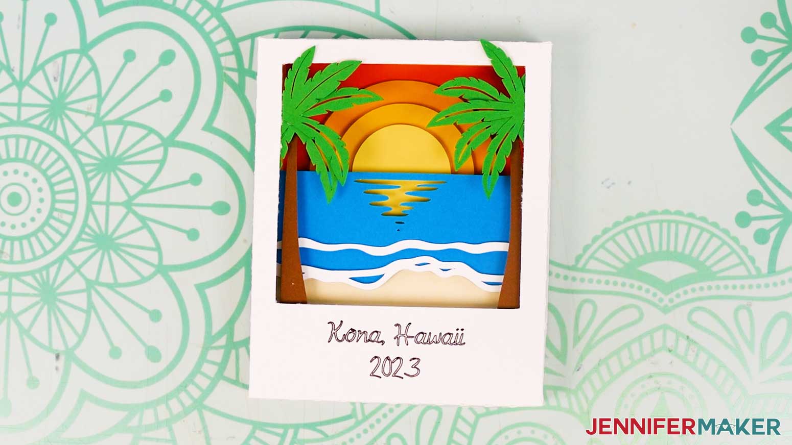 The finished cardstock Polaroid Shadow Box with beach design layers showing a sunset, palm trees, and the ocean.