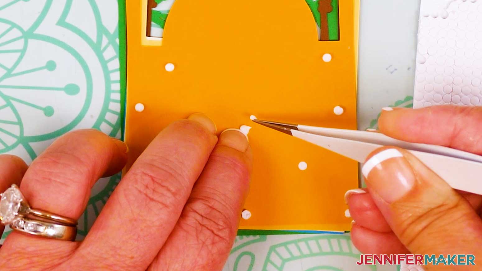 Use tweezers to remove the backing papers from the micro pop dots.