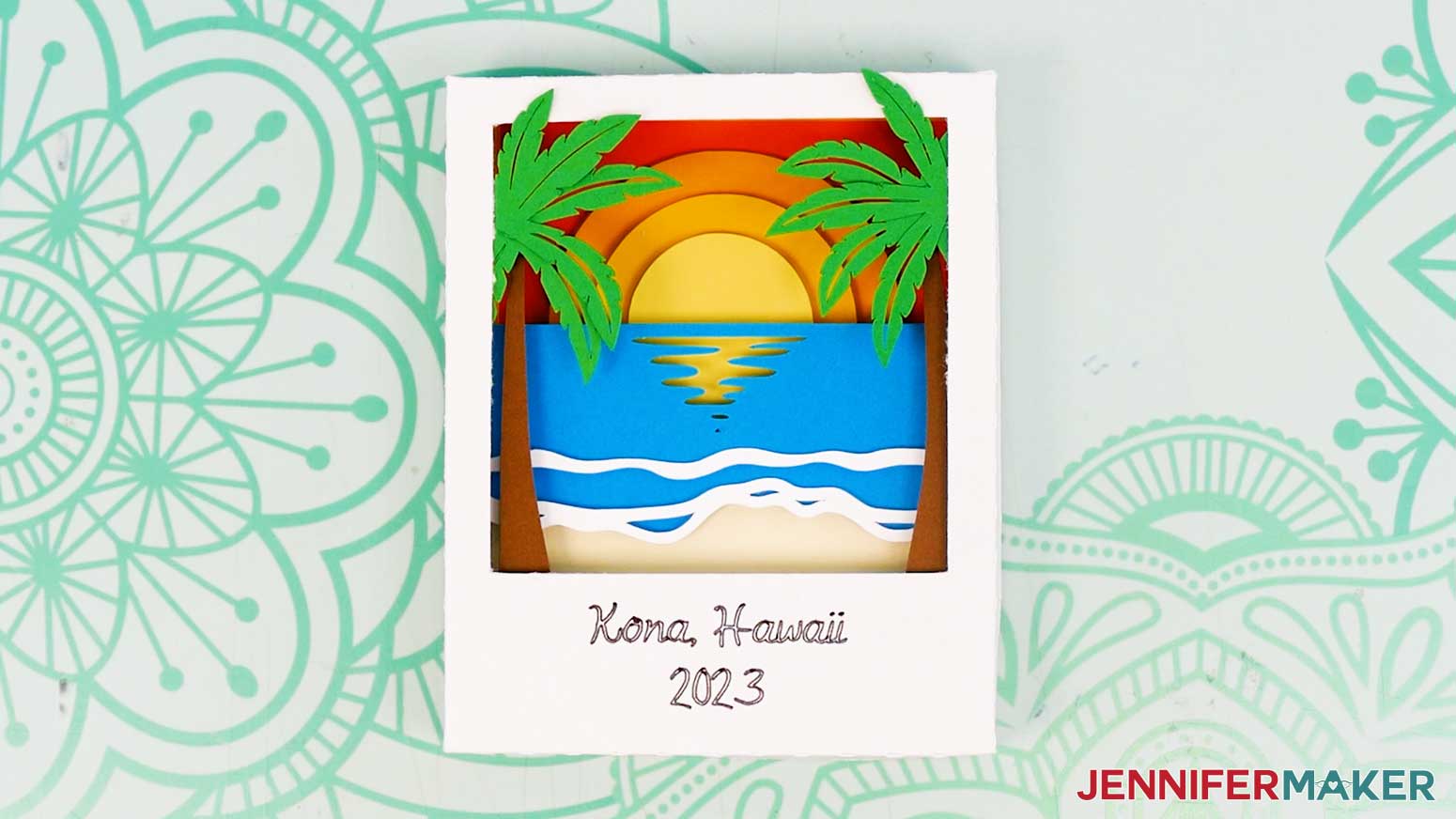 The finished cardstock Polaroid Shadow Box with beach design layers showing a sunset, palm trees, and the ocean.