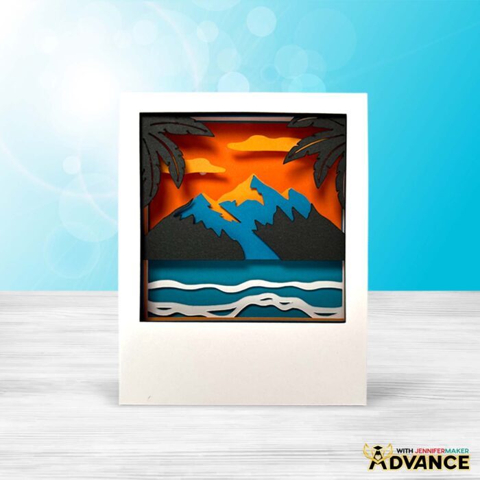 A Polaroid Shadow Box project made of colored cardstock, featuring a mountain at sunset