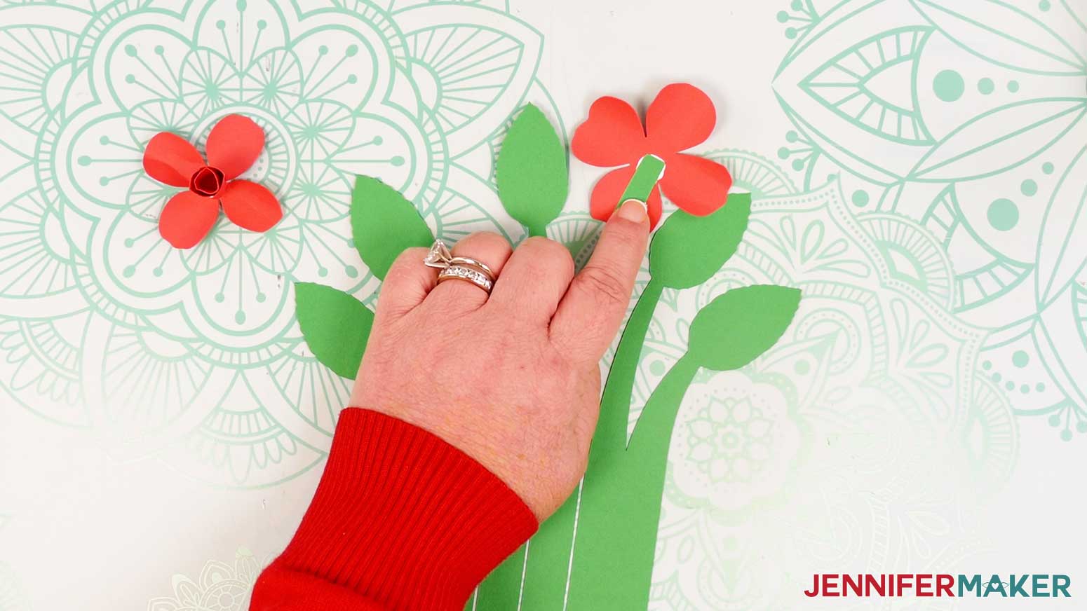 Slide the back rose piece underneath a stem so that the stem’s top is in the center of the flower.