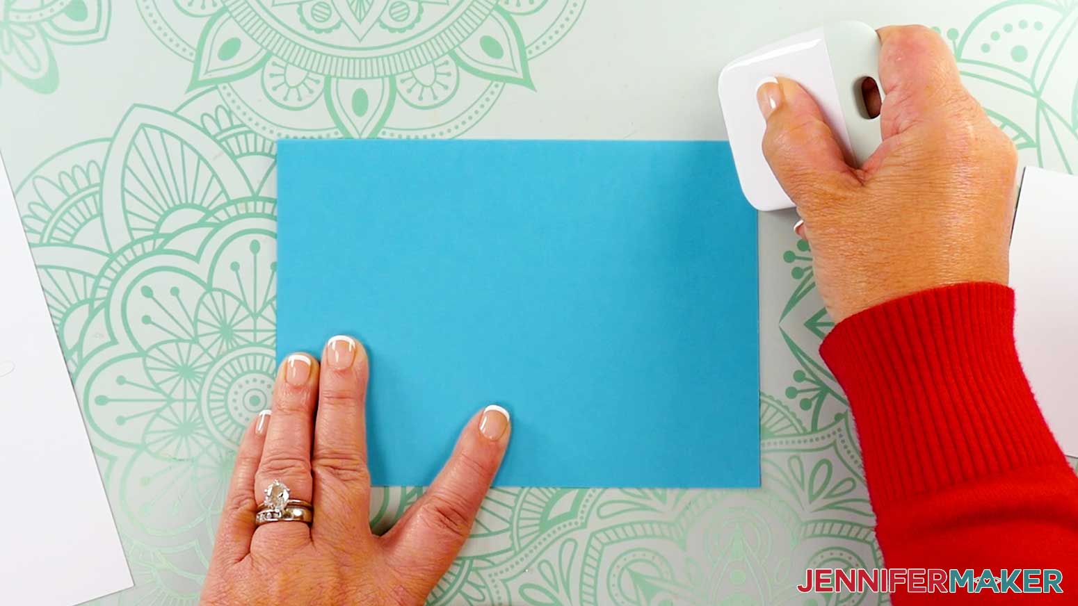 Using a scraper tool to fold the card center