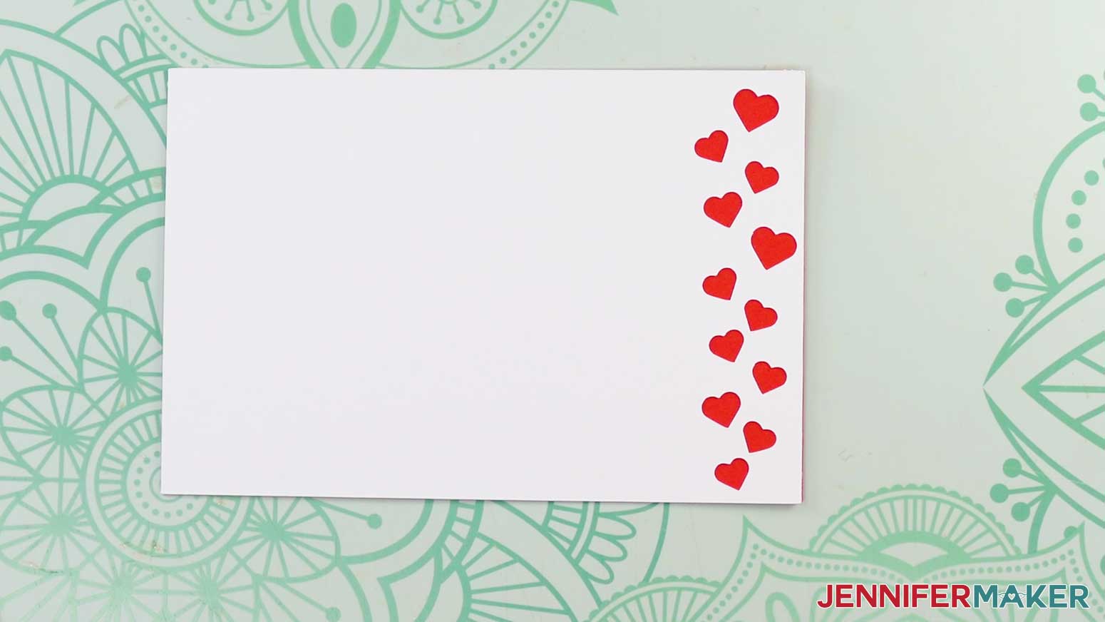 Front panel of love design card face up and glued to red cardstock
