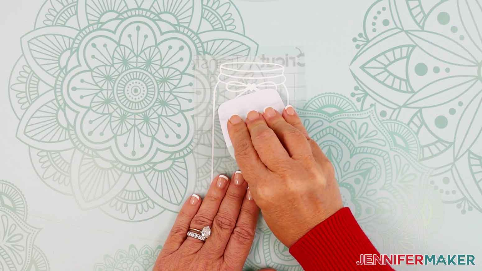 Use a scraper tool to burnish the transfer tape to the vinyl.