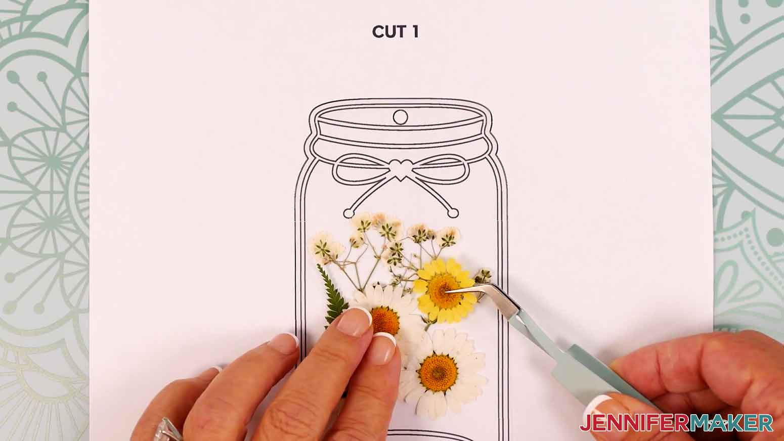 Use tweezers to arrange the dried flowers on the laminate.