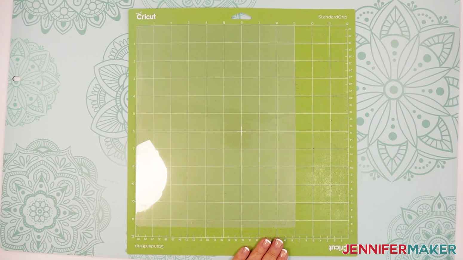 Place the laminate sheet in the upper left corner of the machine mat.