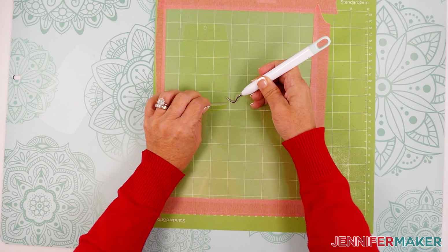 Use a weeding tool to remove the laminate cut design from the machine mat.