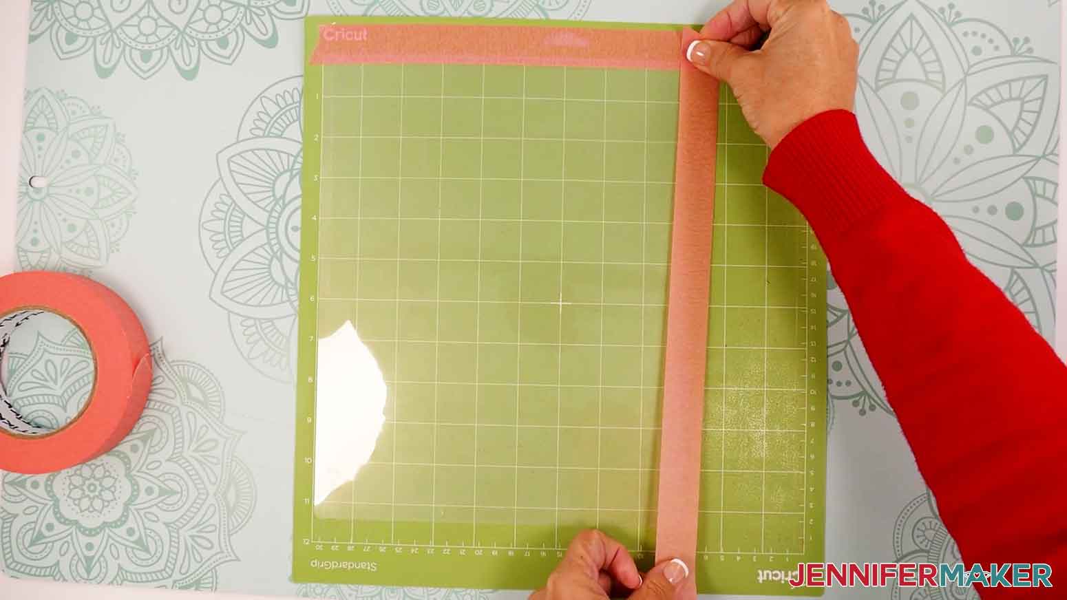 Use painter's tape on the edges of the laminate to secure it to the machine mat.