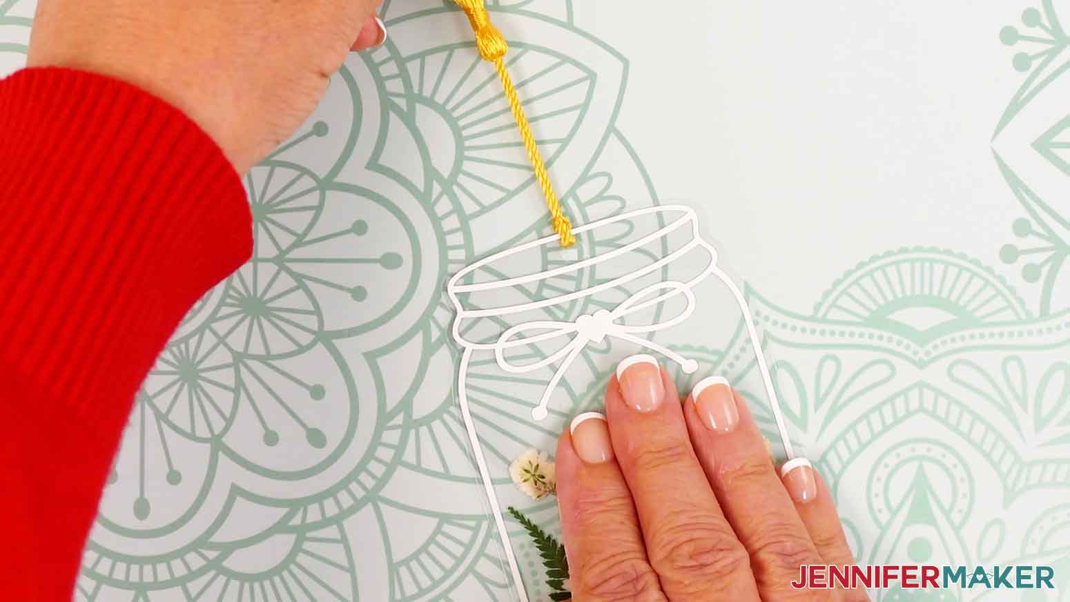 Loop the tassel end through the hole and pull tight to secure.