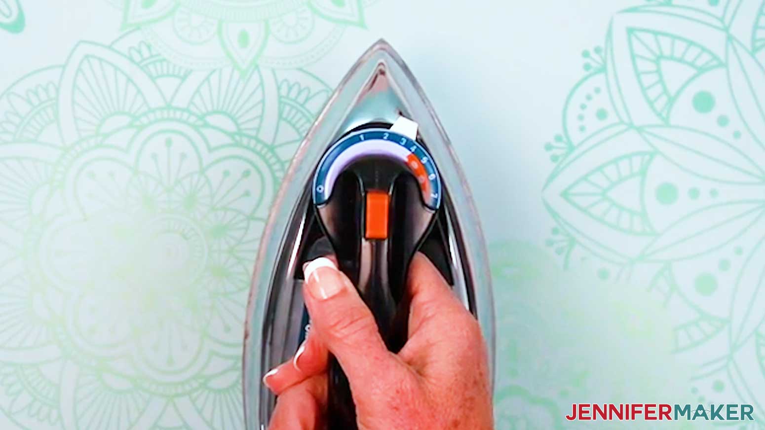 Set the iron to a medium heat setting.