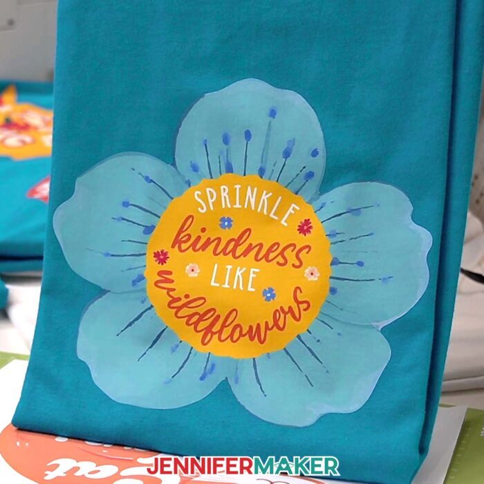 Turquoise T-shirt with a Print Then Cut Iron-On design of a bloom with a quote "Sprinkle Kindness like Wildflowers"