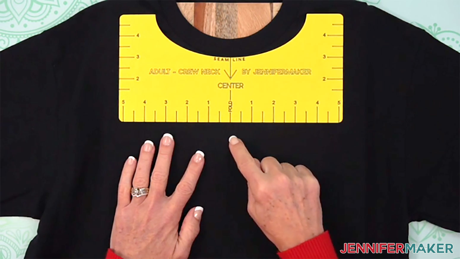 Measure or use a shirt ruler to determine the correct spot for the metallic puff vinyl design to be placed onto the shirt.