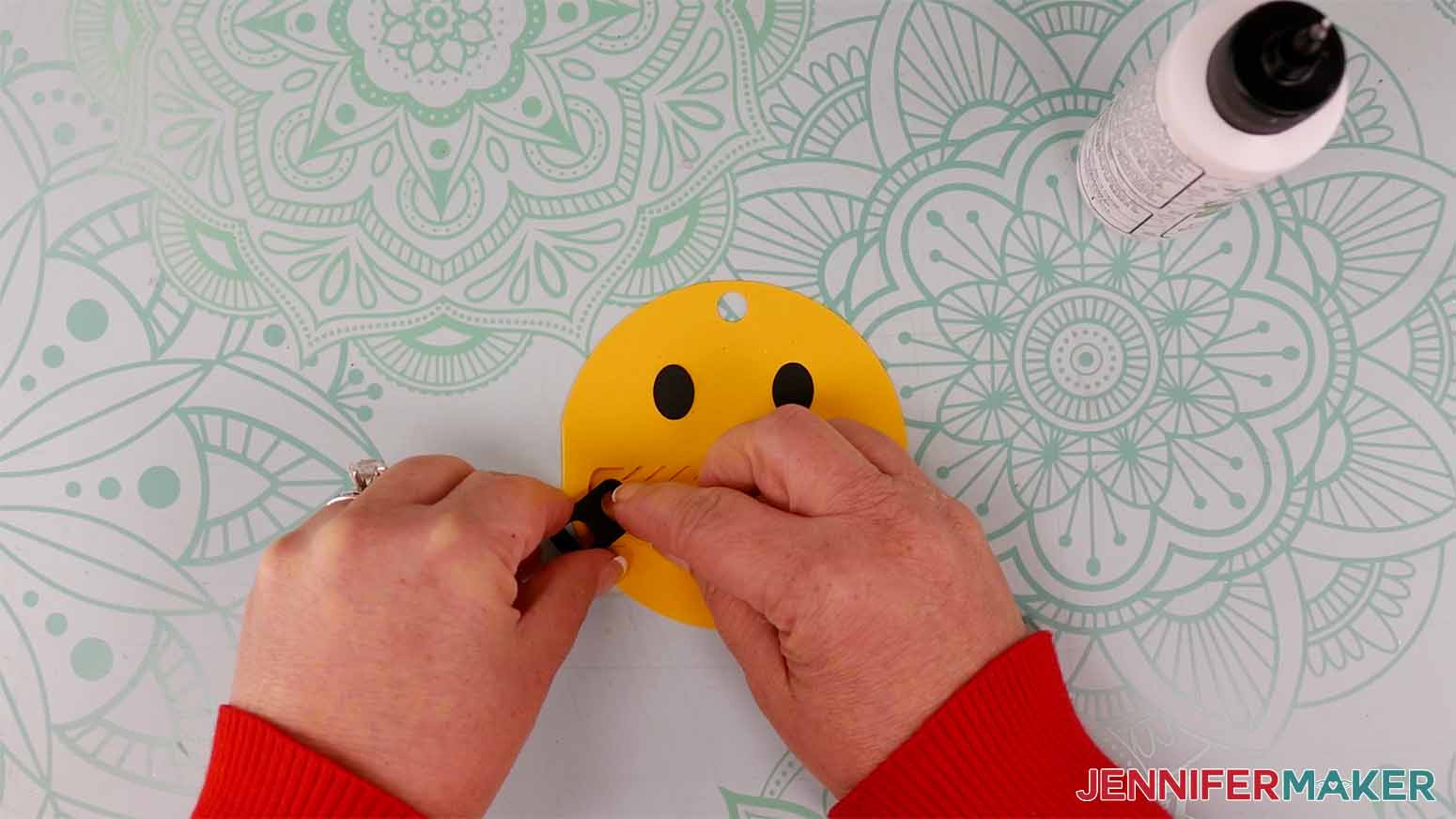 Use craft glue to attach the eyes and zipper pieces to the front of the emoji gift tag.