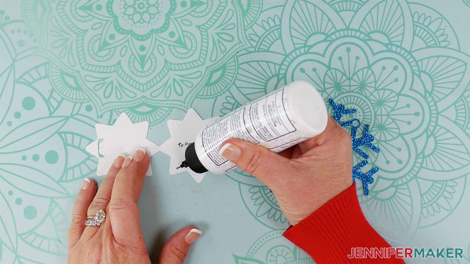 Apply a thin line of craft glue around the insde edges of the snowflake gift tag center.