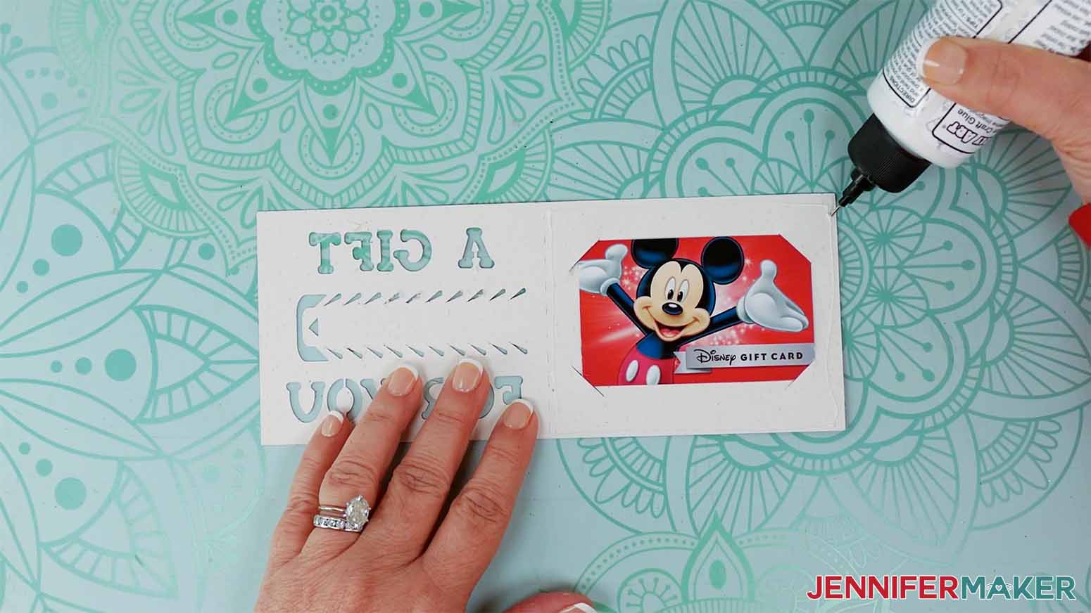 Apply a thin line of craft glue around the edge of the gift card envelope.