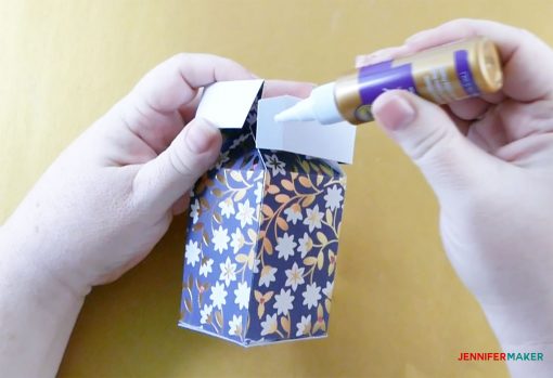 Glue the tab at the top of the pull-up gift box