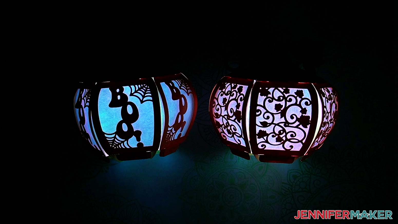 Fully assembled and lit 3D pumpkin lanterns with "boo!" and leaf pattern panels