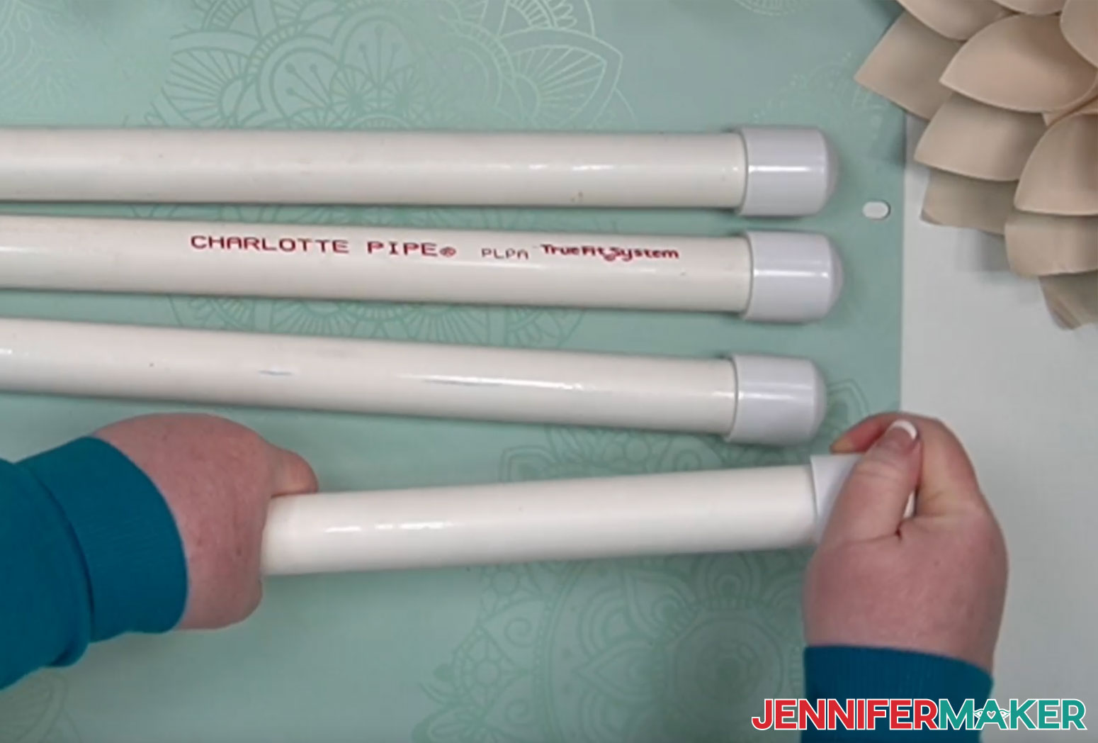 Putting PVC slip caps onto the ends of 1" PVC pipes to make a DIY PVC pipe backdrop stand