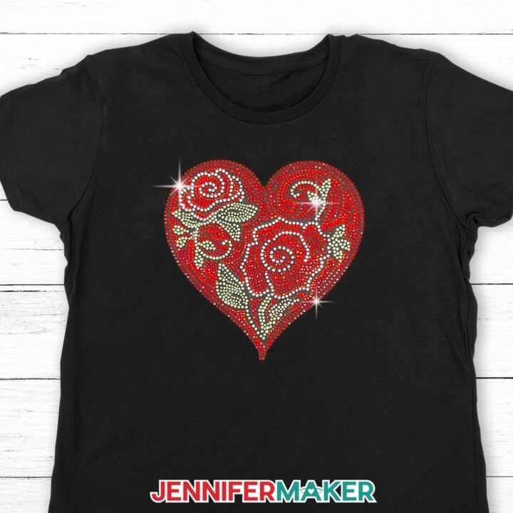 Sparkling rhinestone heart design with roses on a black t-shirt. Learn to create rhinestone templates with Cricut with JenniferMaker's tutorial!