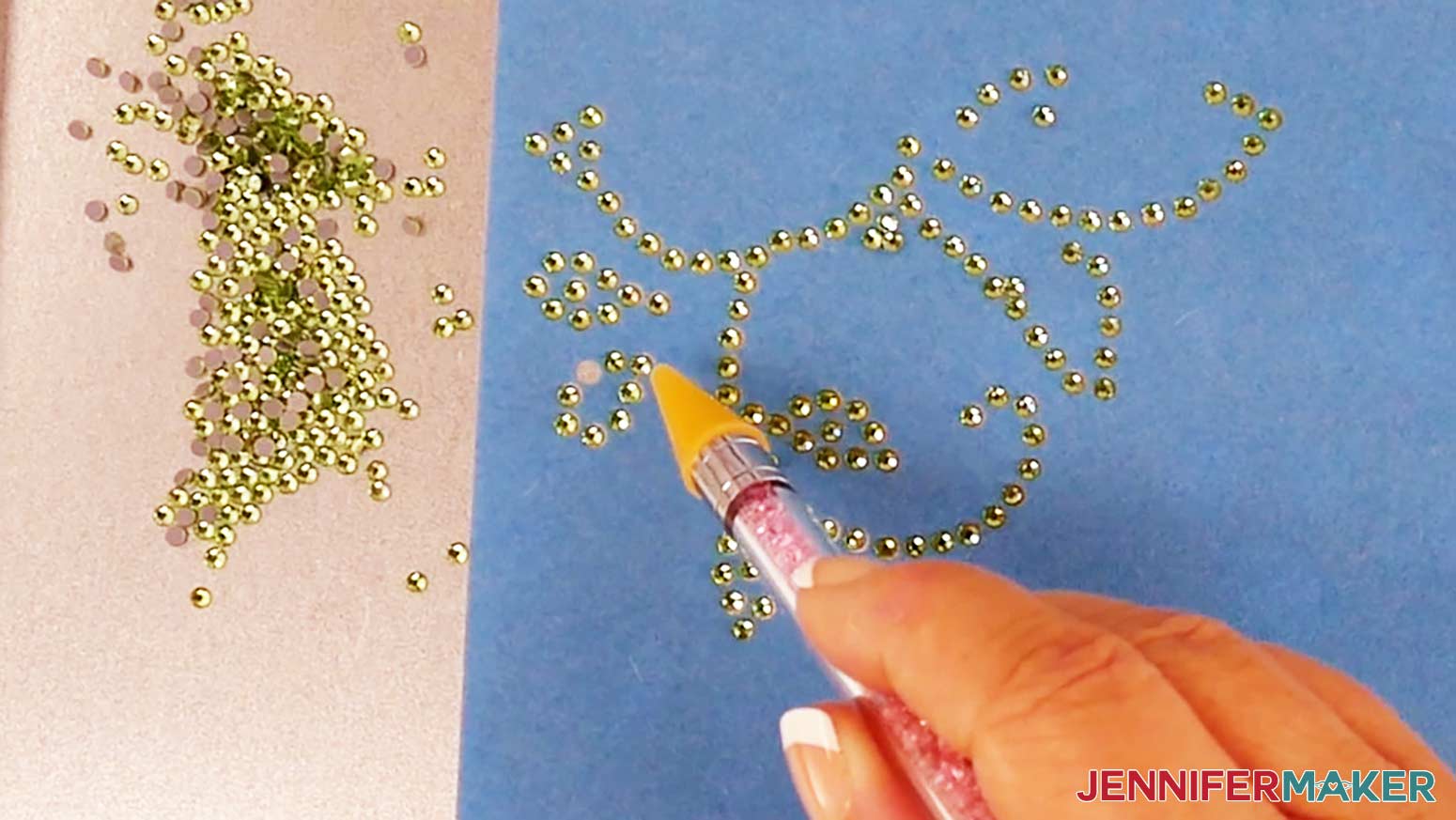 Use a rhinestone picker tool to pick up individual rhinestones to fill in empty holes.