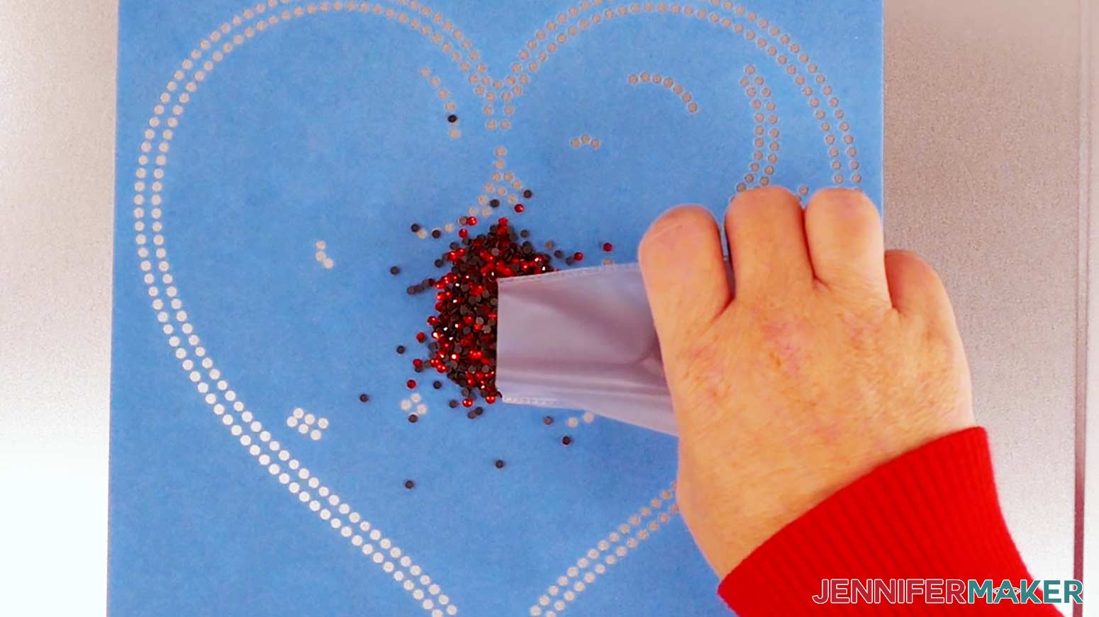Pour a bag of gems onto the rhinestone template.