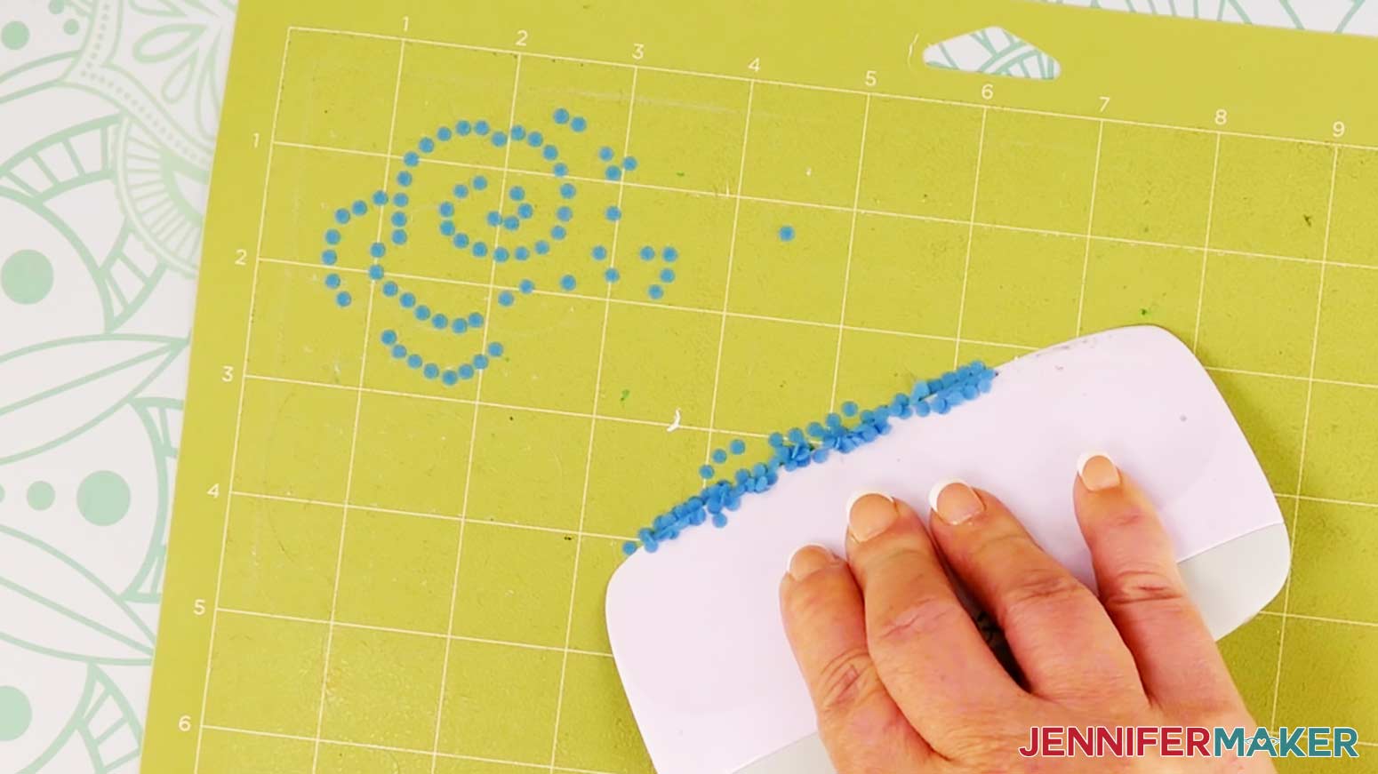 Use a scraper to remove the pieces of flock remaining on the cutting mat.