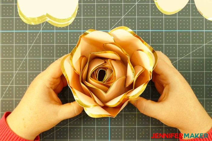 Pink paper with gold foil edges shaped into a big bud for a rose gold paper flower