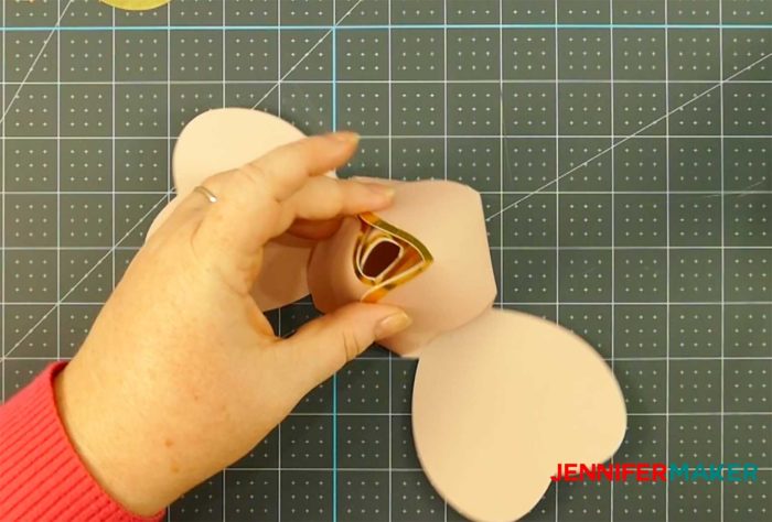 Gluing petals to make a rose gold paper flower