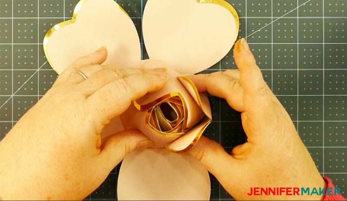 Pink paper with gold foil edges formed into a bud to make a giant rose gold paper flower