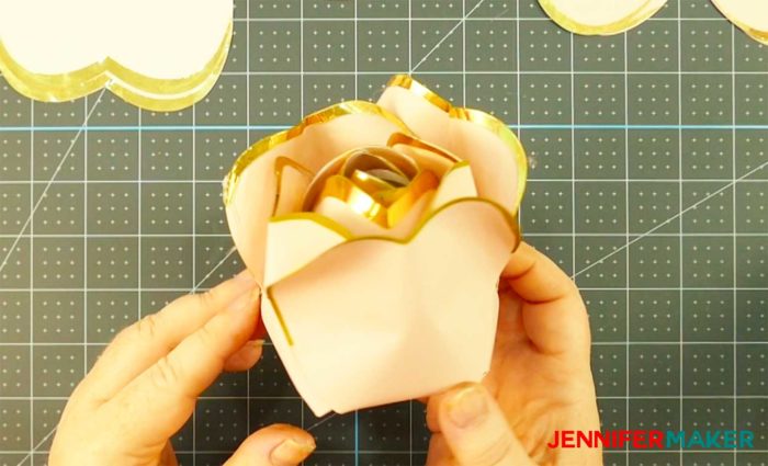 Pink paper with gold foil edges formed into a bud to make a giant rose gold paper flower