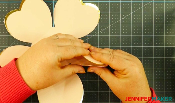 Folding the pink cardstock petals to make a rose gold paper flower