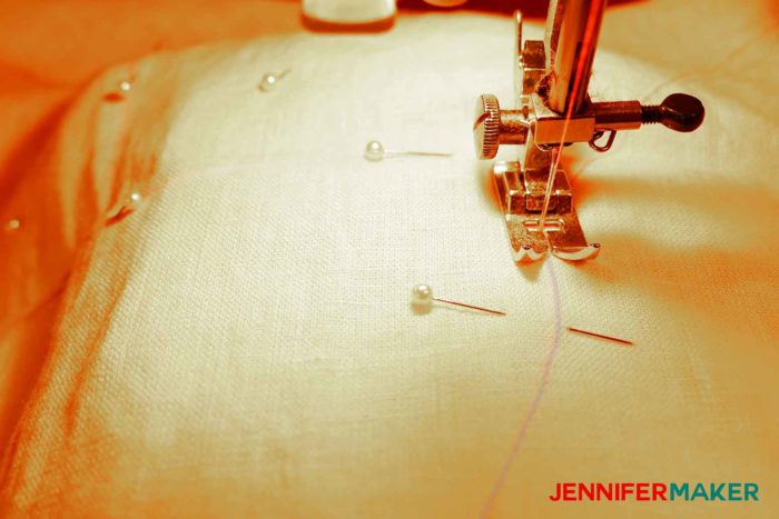 Sewing the facing to the garment to sew a round jewel neckline on a shirt or tunic