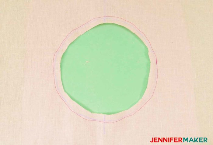 Cut out the circle of the facing to sew a round jewel neckline on a shirt or tunic