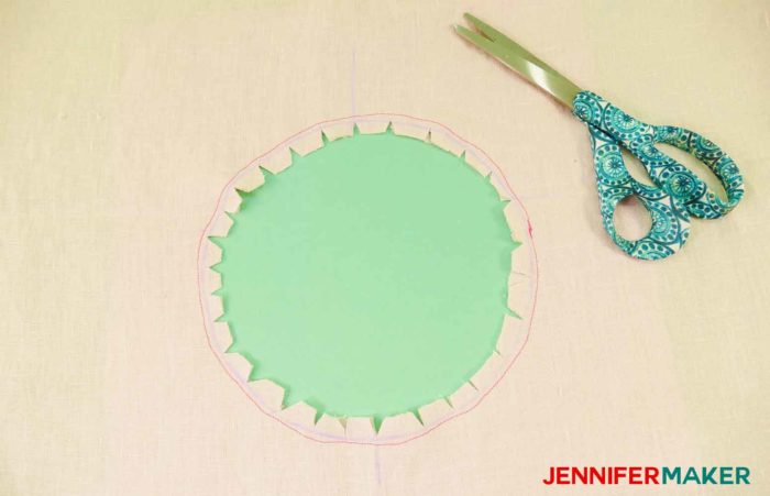 Make small cuts inside the perimeter of the circle to sew a round jewel neckline on a shirt or tunic