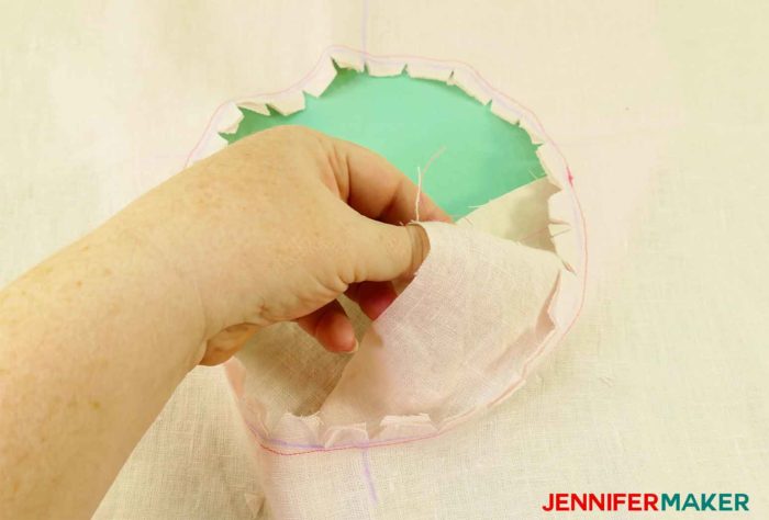 Pulling the facing inside out to sew a round jewel neckline on a shirt or tunic