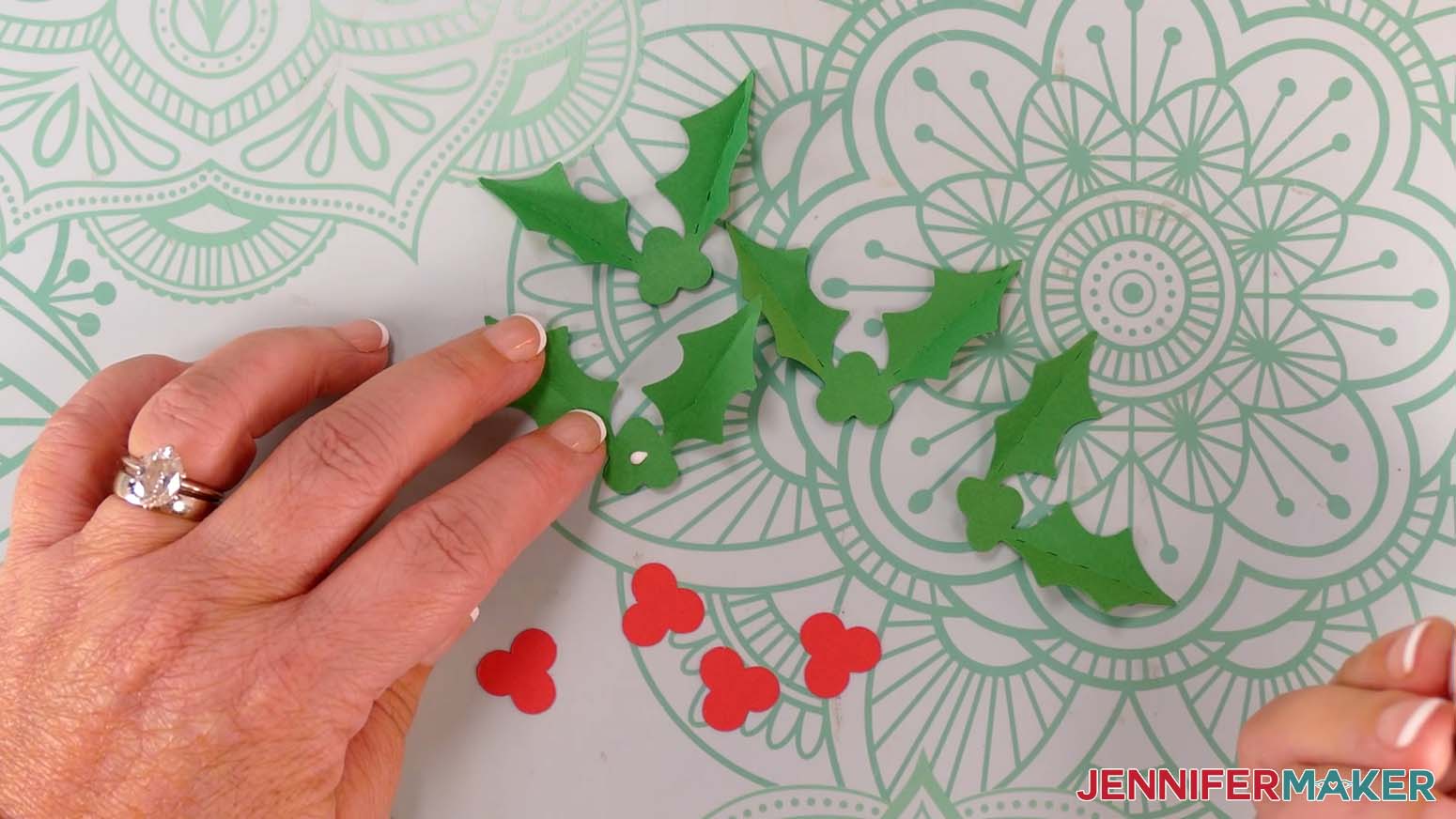 Apply a small amount of craft glue to the center area of the Santa purse holly leaf piece where the berry piece will go.