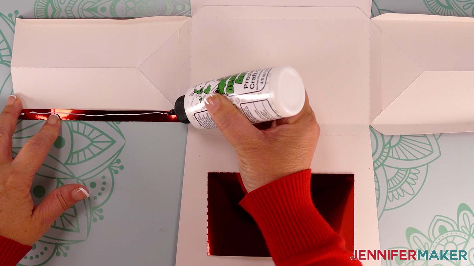 Apply craft glue to the tab on the left side of the Santa purse.